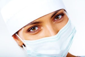 Close-up of medical nurse in mask looking at camera