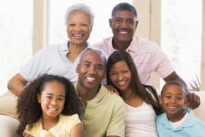 family sitting on a couch visits optometrists each year